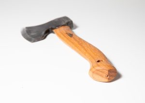 Hand-forged Gränsfors Small Carving Axe with its vegetable-tanned leather sheath, ideal for sloyd and spoon carving.