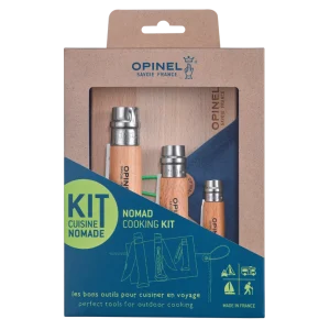 A portable Opinel Nomad Cooking Kit featuring three folding knives with beechwood handles—a serrated bread knife, a folding peeler, and a large corkscrew knife—laid out on a blue microfiber cleaning cloth next to a small wooden cutting board.